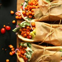Amazing vegan Buffalo Chickpea Wraps served on pita bread