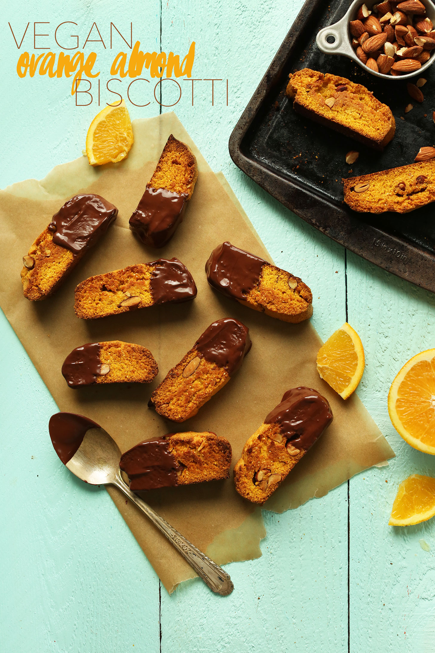 Parchment paper with a batch of our delicious vegan chocolate-dipped orange biscotti