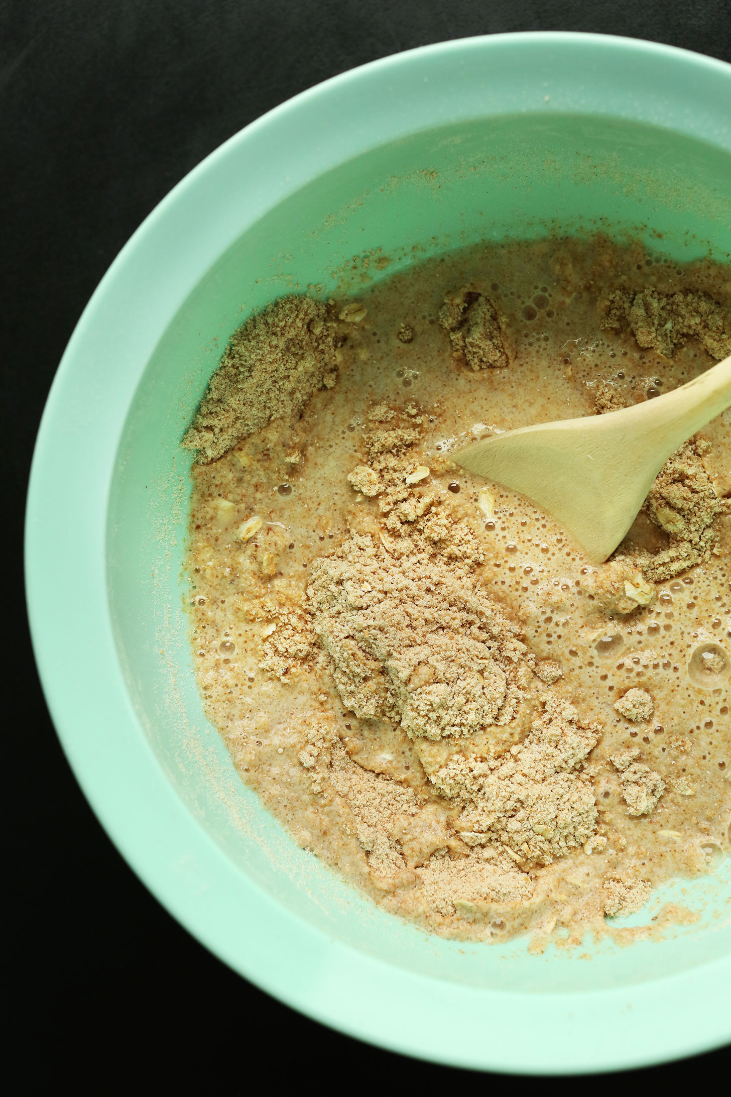 Mixing wet ingredients into dry for our delicious vegan toasted coconut pancakes recipe