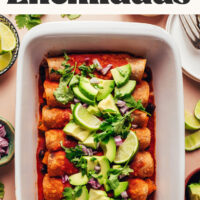 Baking pan of vegan gluten-free butternut squash black bean enchiladas