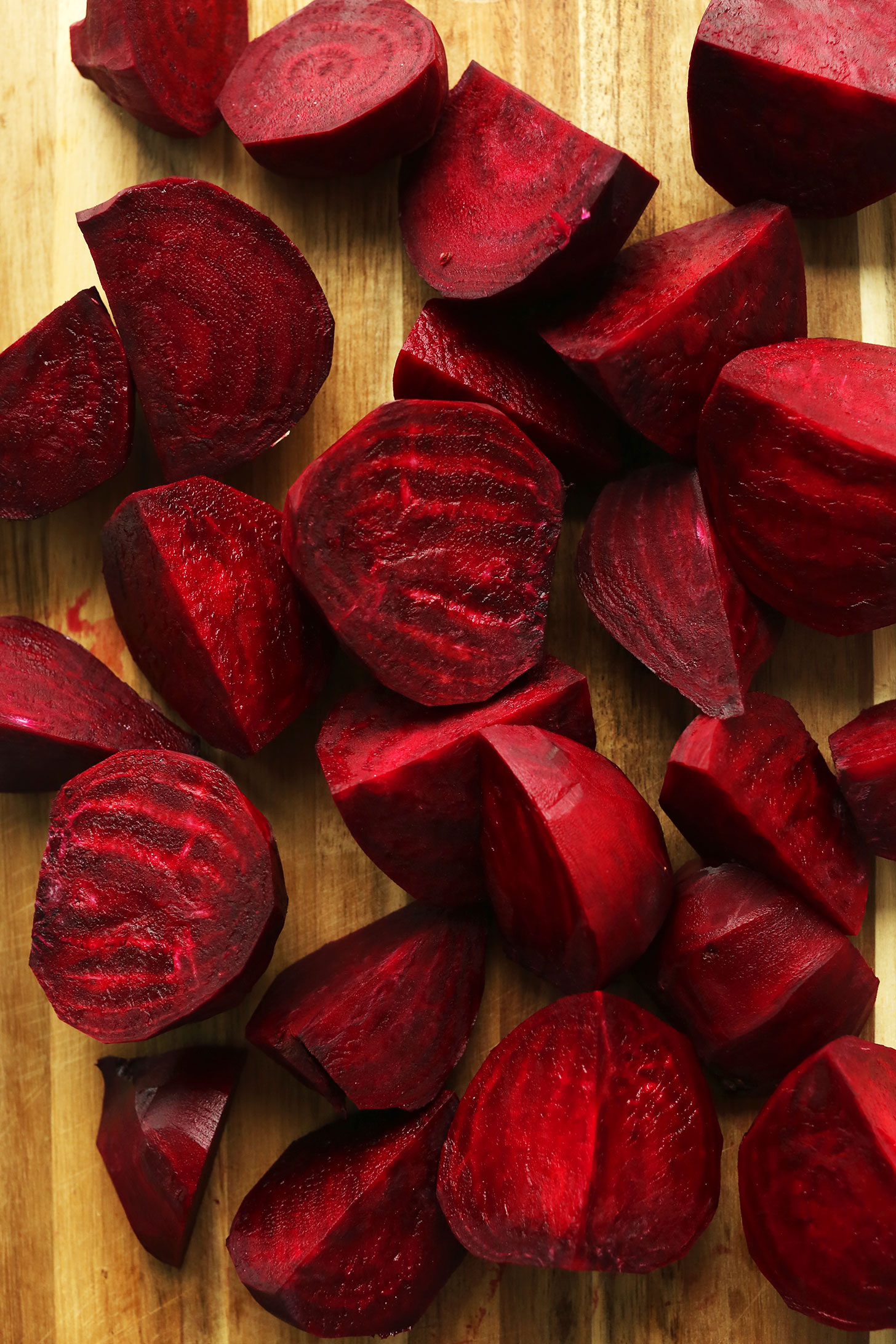 Freshly chopped beets on a cutting board for making vegan Curried Beet Soup