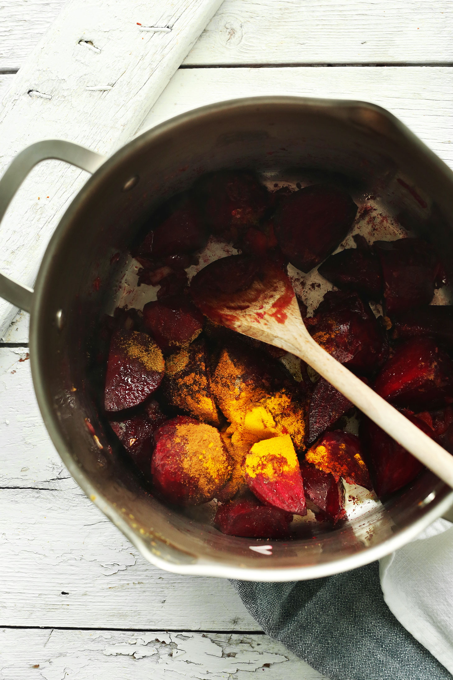 Sautéing beets with curry powder in a large pot