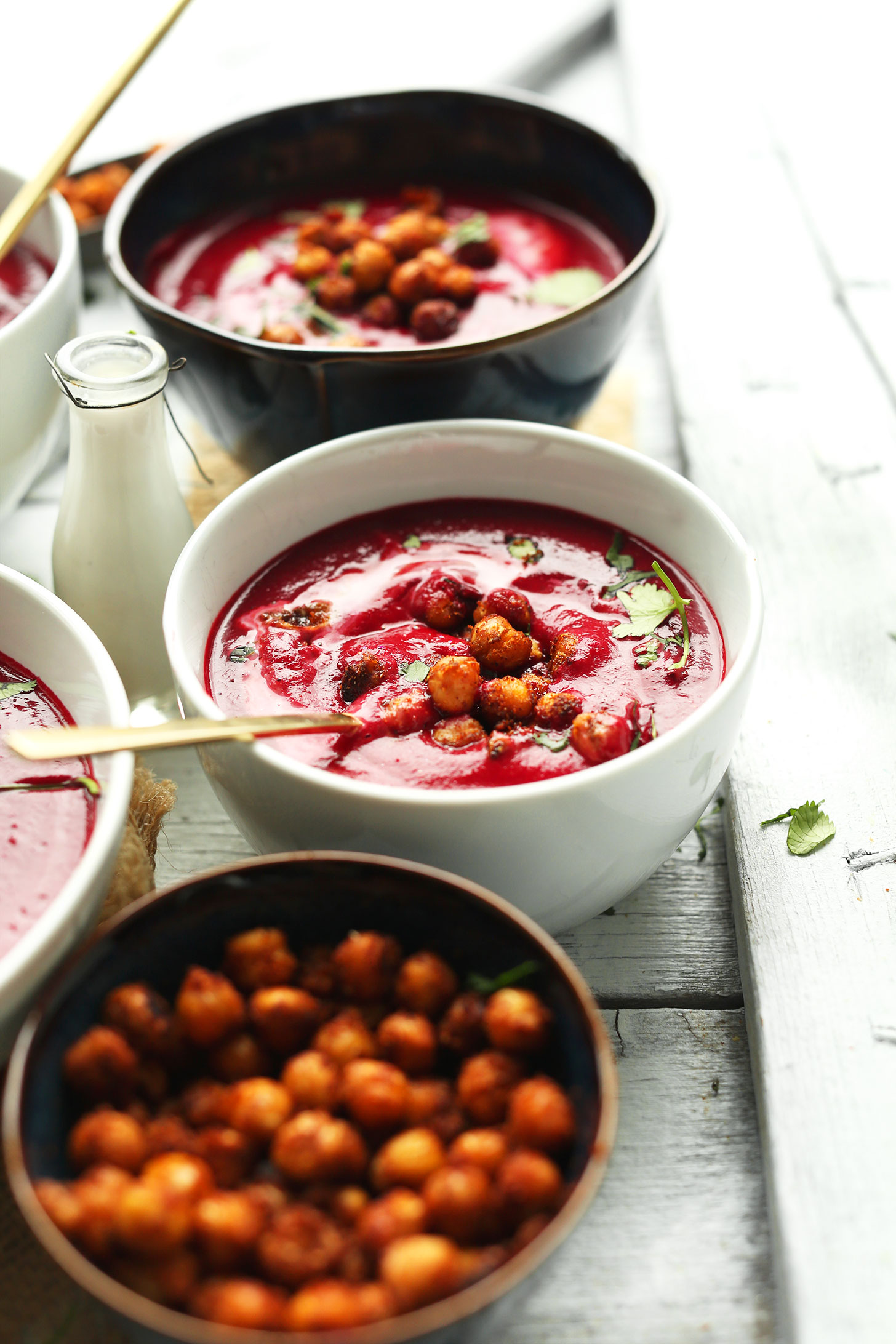 Bowls of our flavorful gluten-free vegan Curried Beet Soup topped with Crispy Tandoori Chickpeas