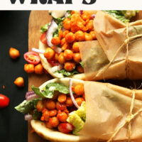Wood cutting board with spicy buffalo chickpea wraps that are ready in 30 minutes