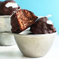 Stack of Raw Double Chocolate Macaroons in a vintage measuring cup