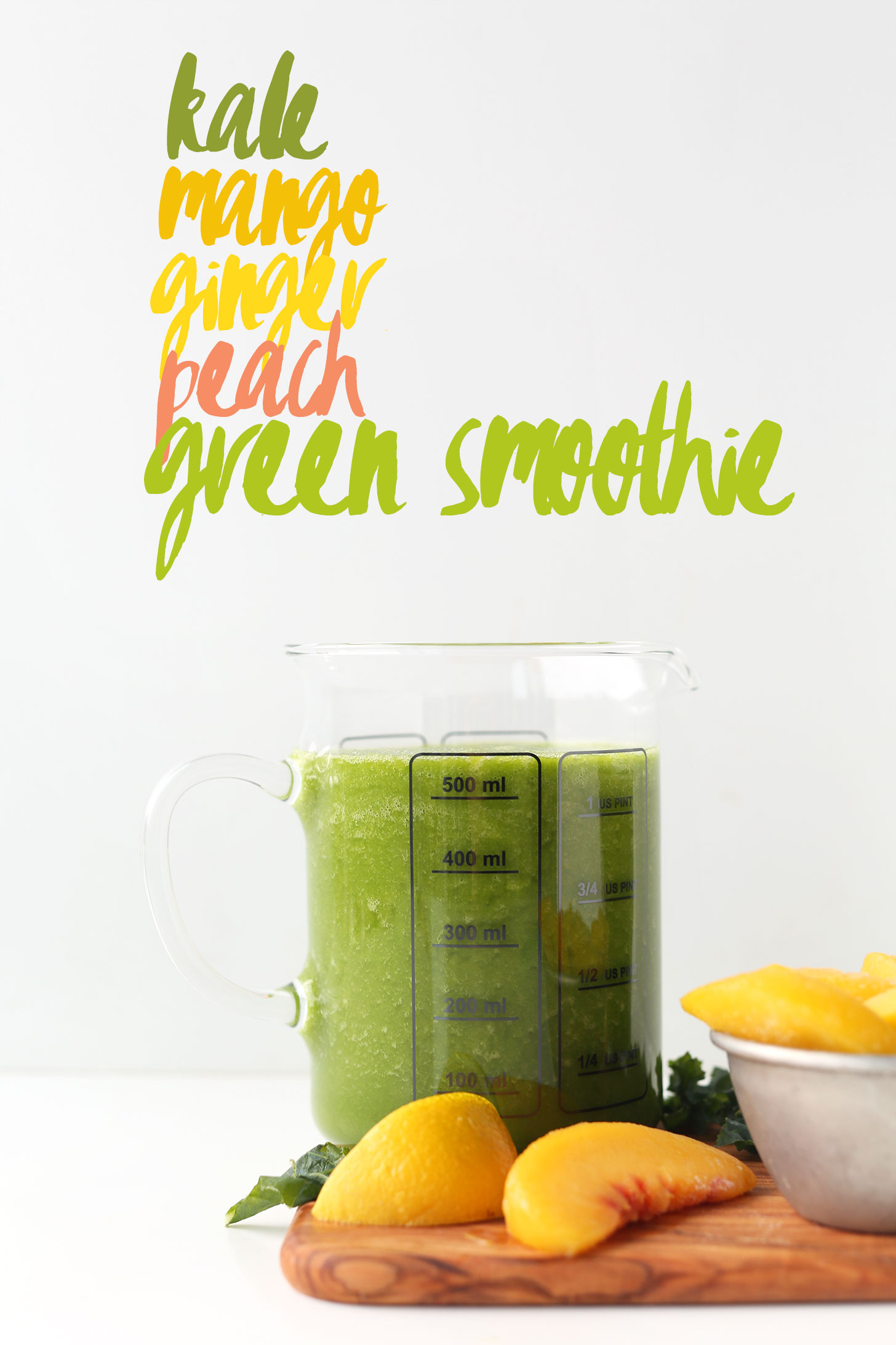 Measuring glass filled with our vegan Mango Ginger Kale Green Smoothie recipe