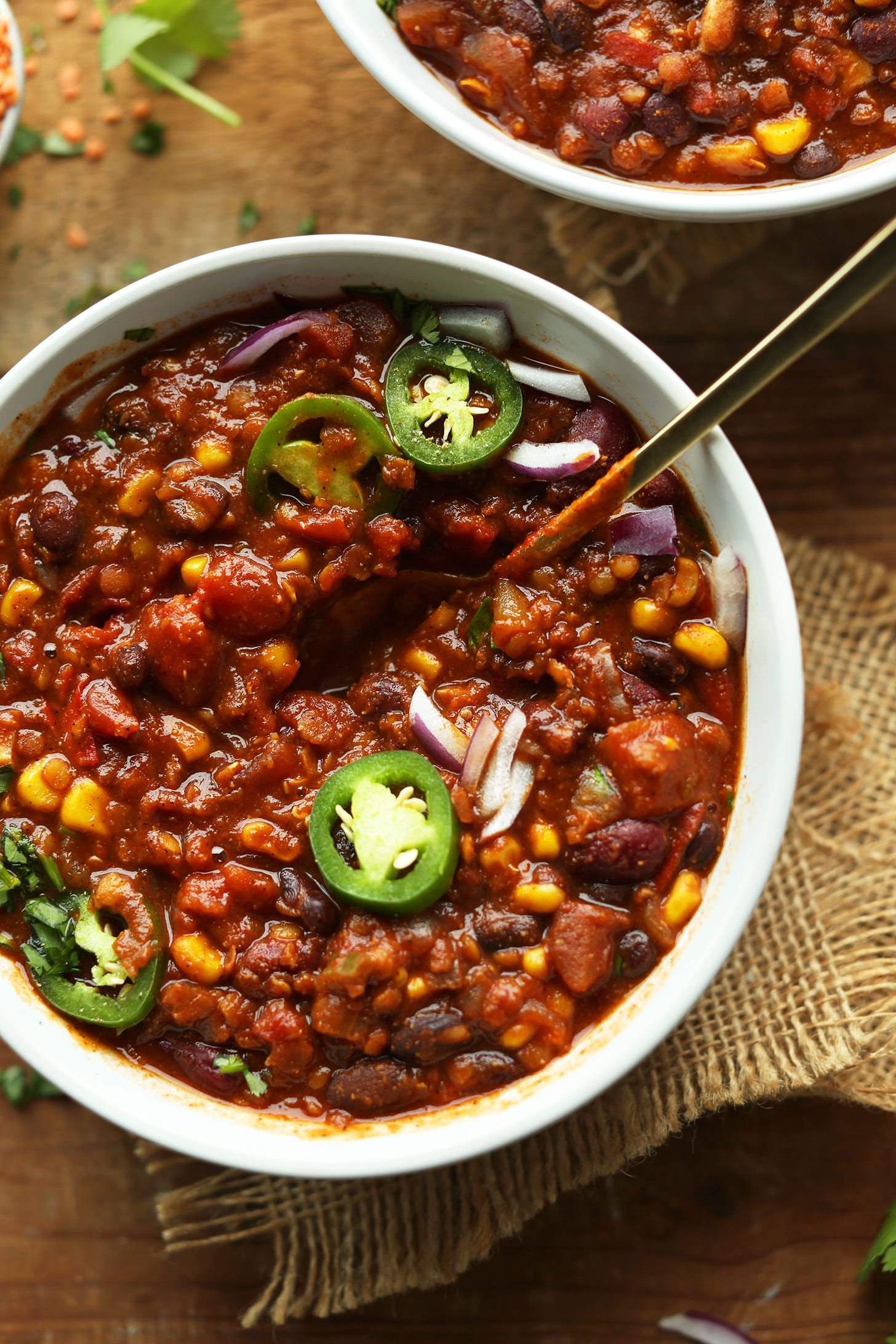 Bowl of our hearty, filling Red Lentil and Black Bean Chili topped with jalapenos