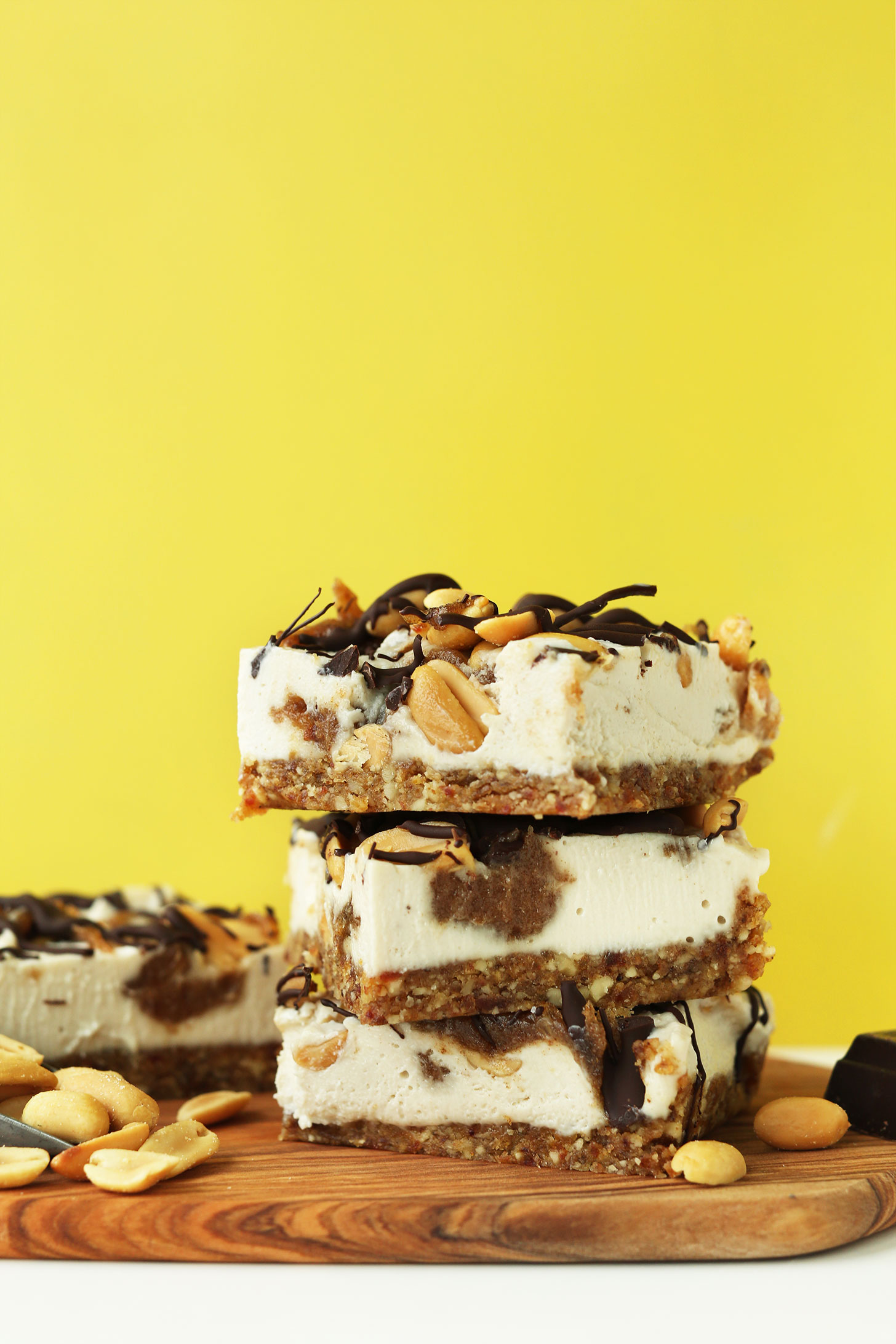 Stack of of our naturally-sweetened Vegan Snickers Cheesecake squares