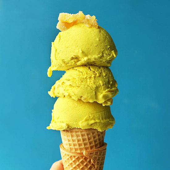 Triple scooped Golden Milk Ice Cream on a stack of sugar cones