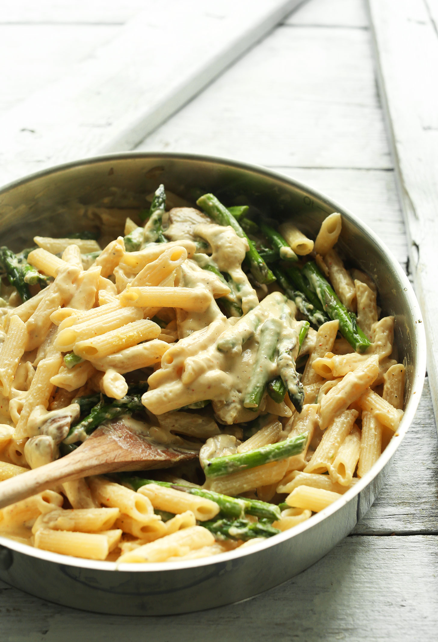 A pan of gluten-free vegan Creamy Asparagus & Mushroom Pasta for a comforting meal