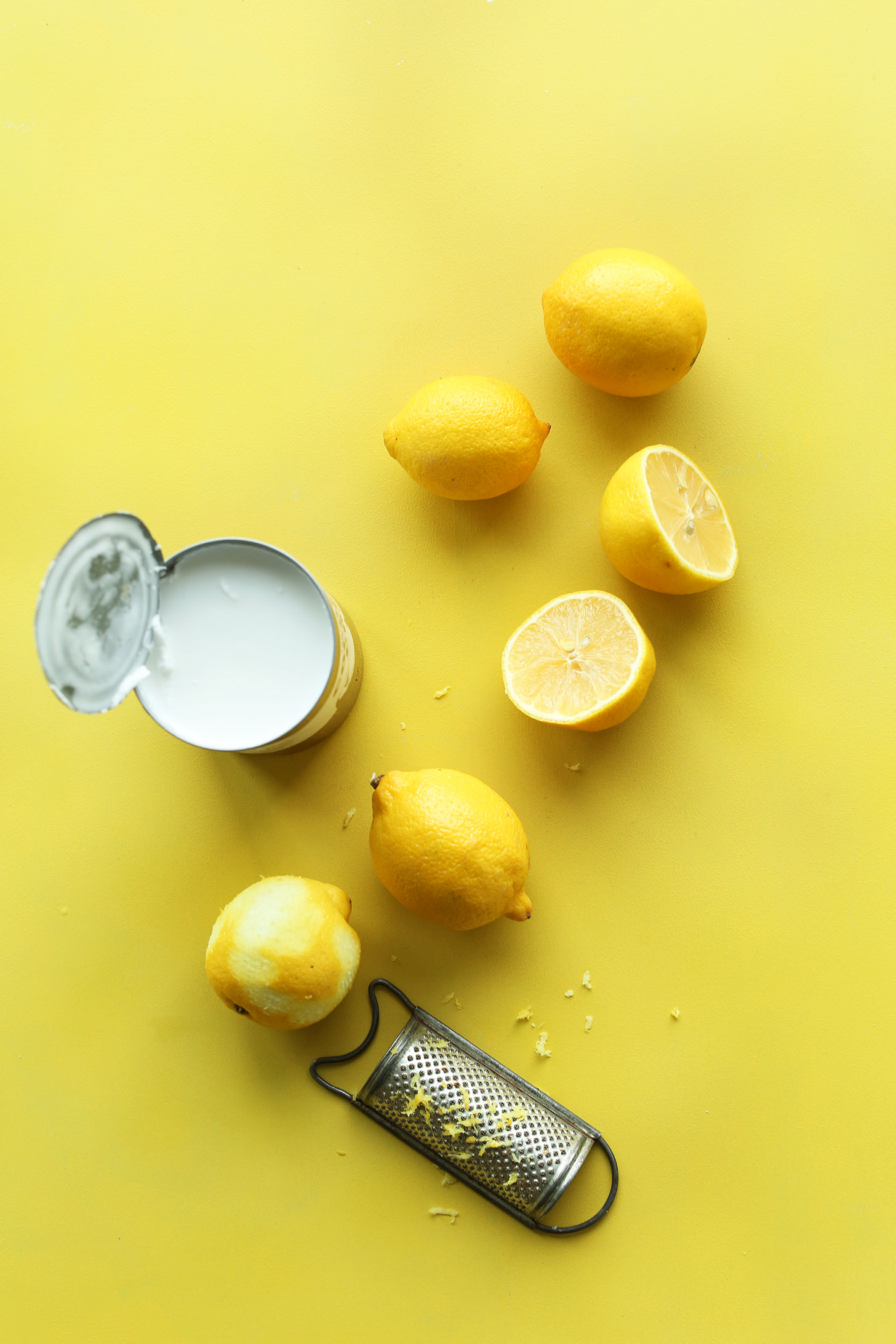 Fresh lemons and coconut milk for making rich and creamy vegan lemon curd