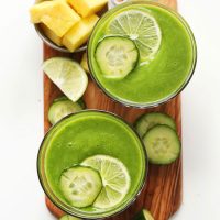 Two glasses of our Healthy Cucumber Smoothie topped with sliced cucumber and lime