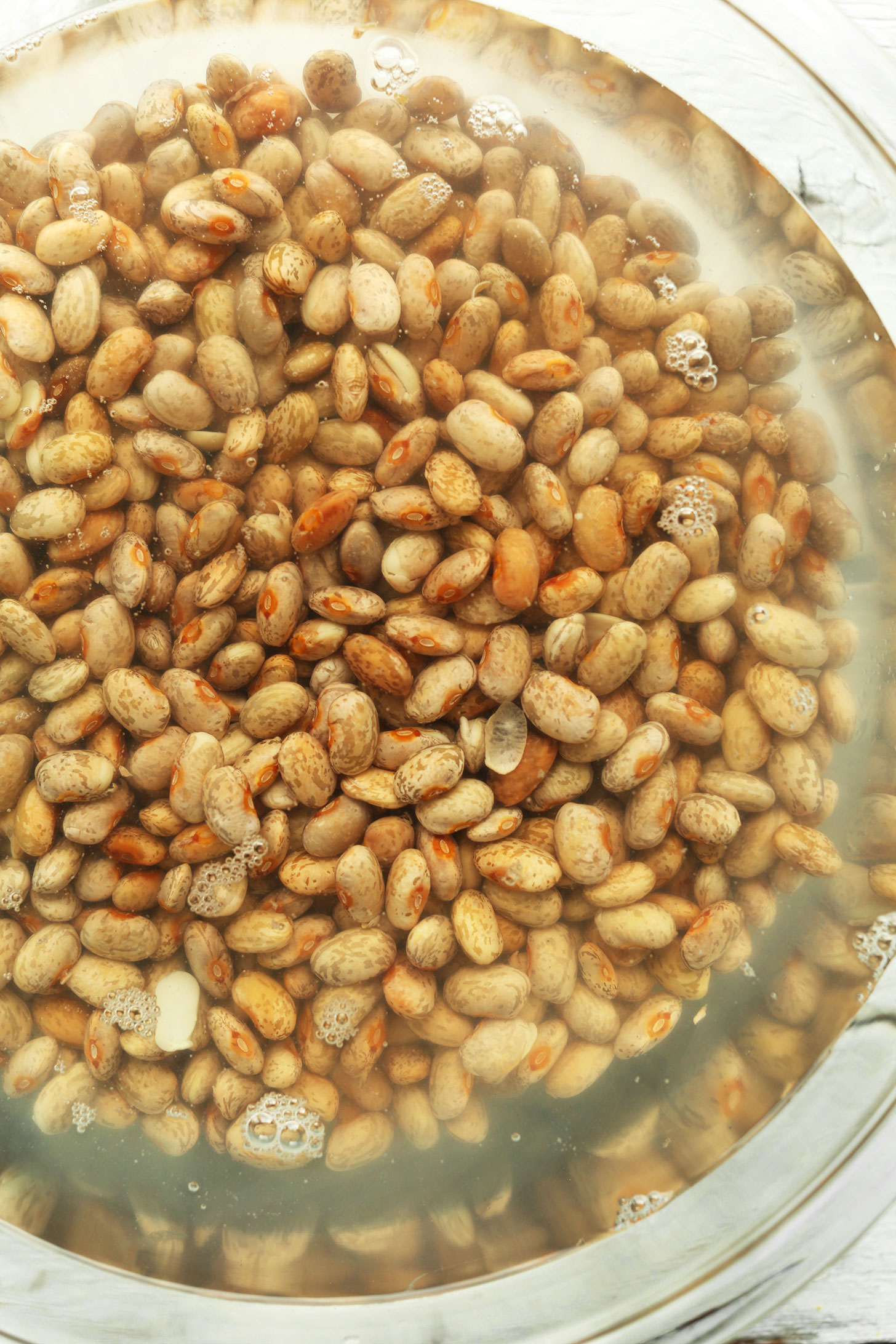 Soaking dry pinto beans in water for our tutorial on How to Cook Pinto Beans