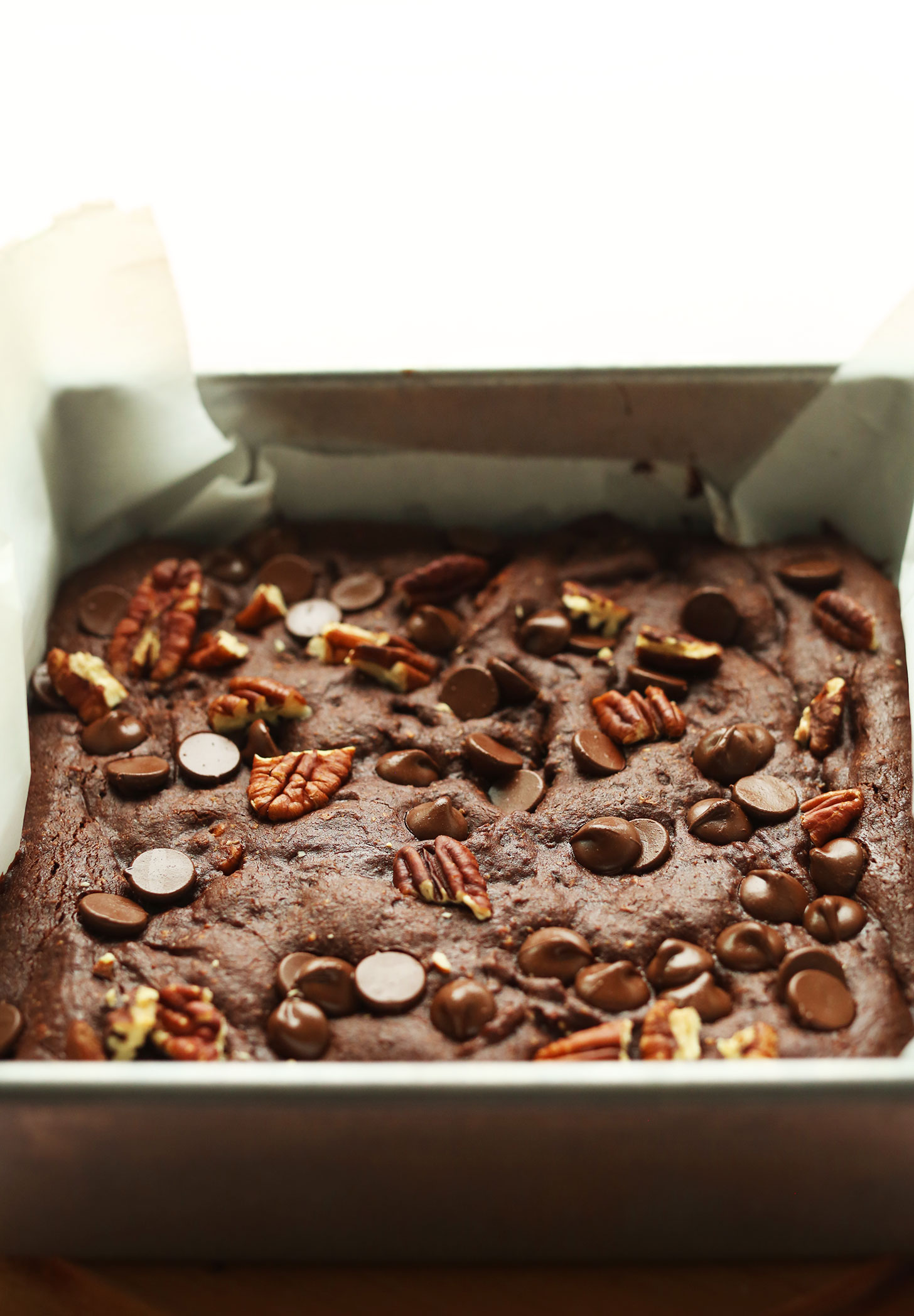 Parchment-lined baking pan with a batch of our Vegan Gluten-Free Brownies recipe