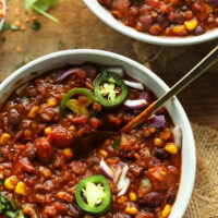 Plant-based and cozy 1-pot red lentil chili written above a bowl of chili
