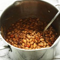 Metal spoon in a big pot of Mexican Pinto Beans made from scratch