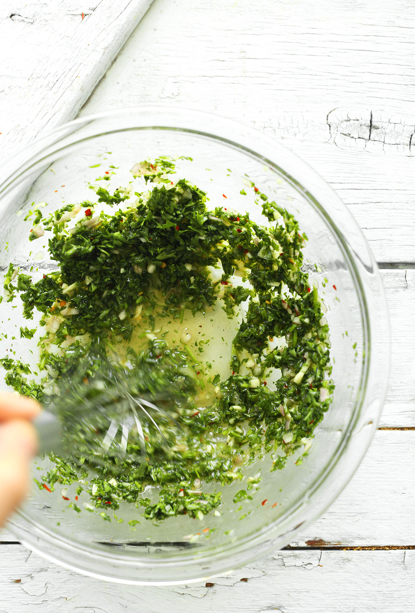 Whisking together ingredients for Avocado Chimichurri