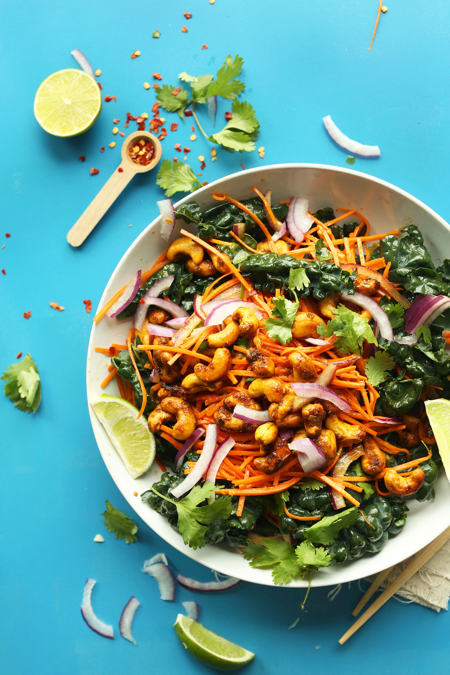 Serving bowl full of our gluten-free vegan Thai Carrot Kale Salad with Curried Cashews