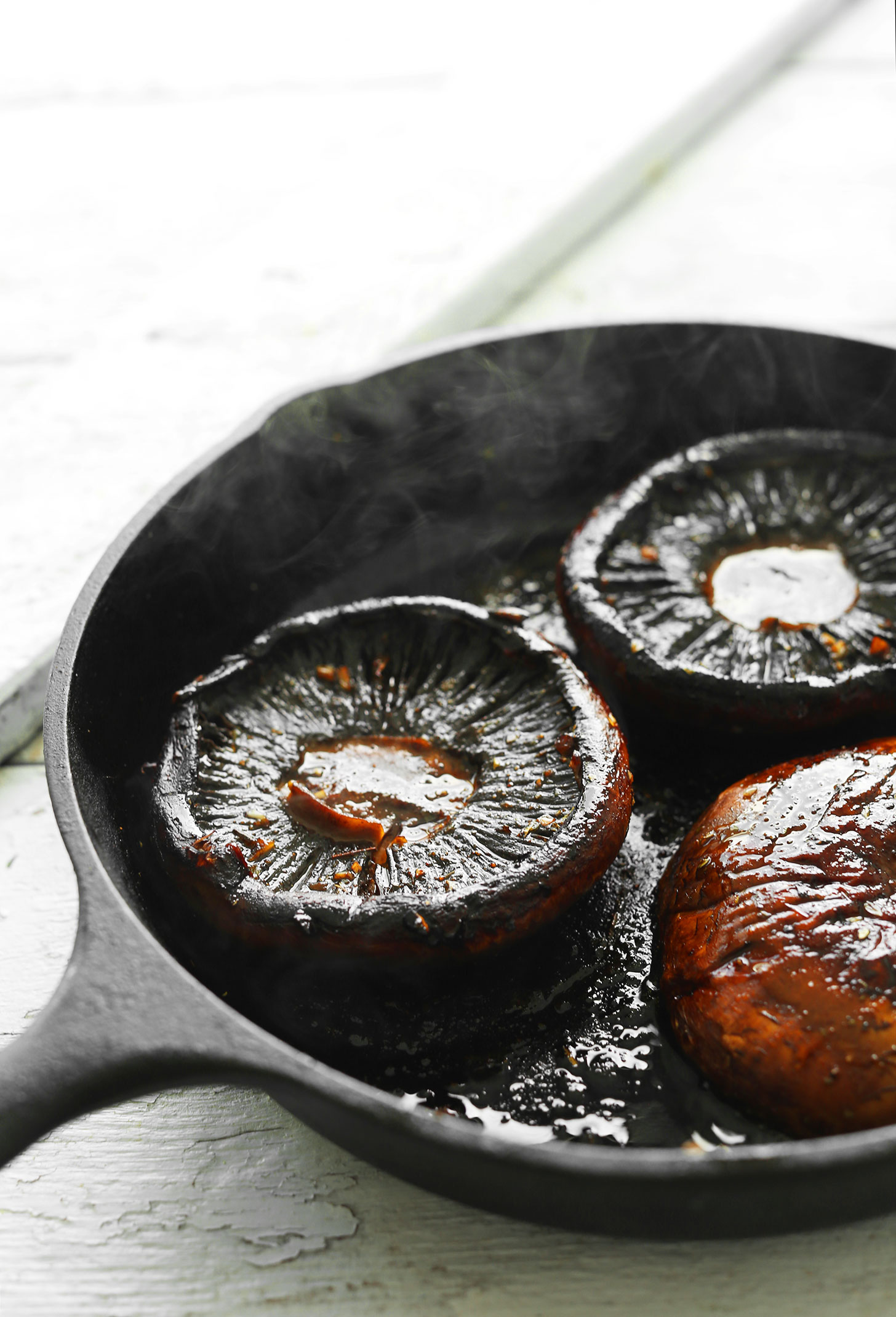 Cooking Portobello Steaks in a cast iron skillet for a healthy plant-based summer meal
