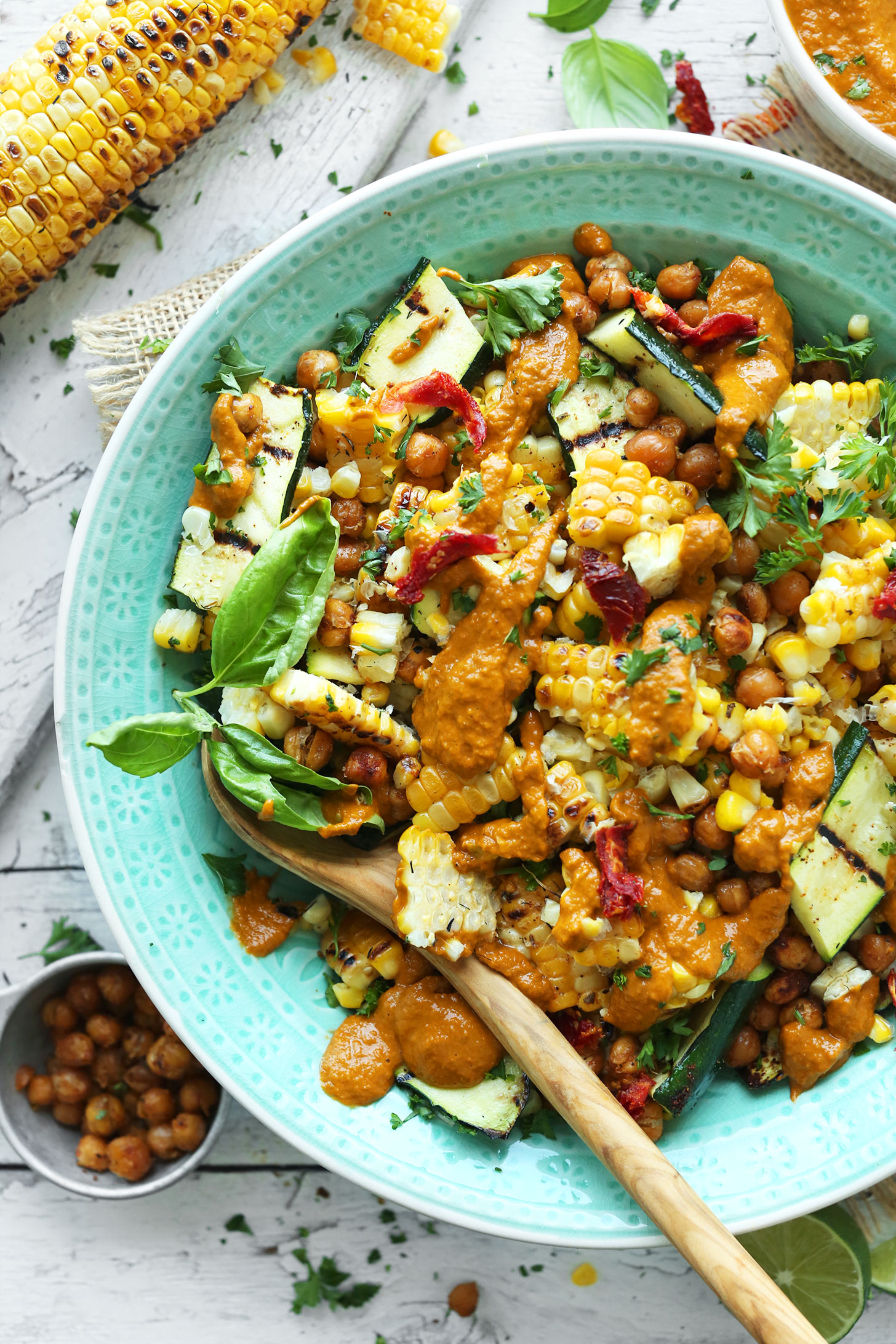 Bowl of our 30-Minute Zucchini & Grilled Corn Salad topped with crispy chickpeas and Sun-Dried Tomato Vinaigrette