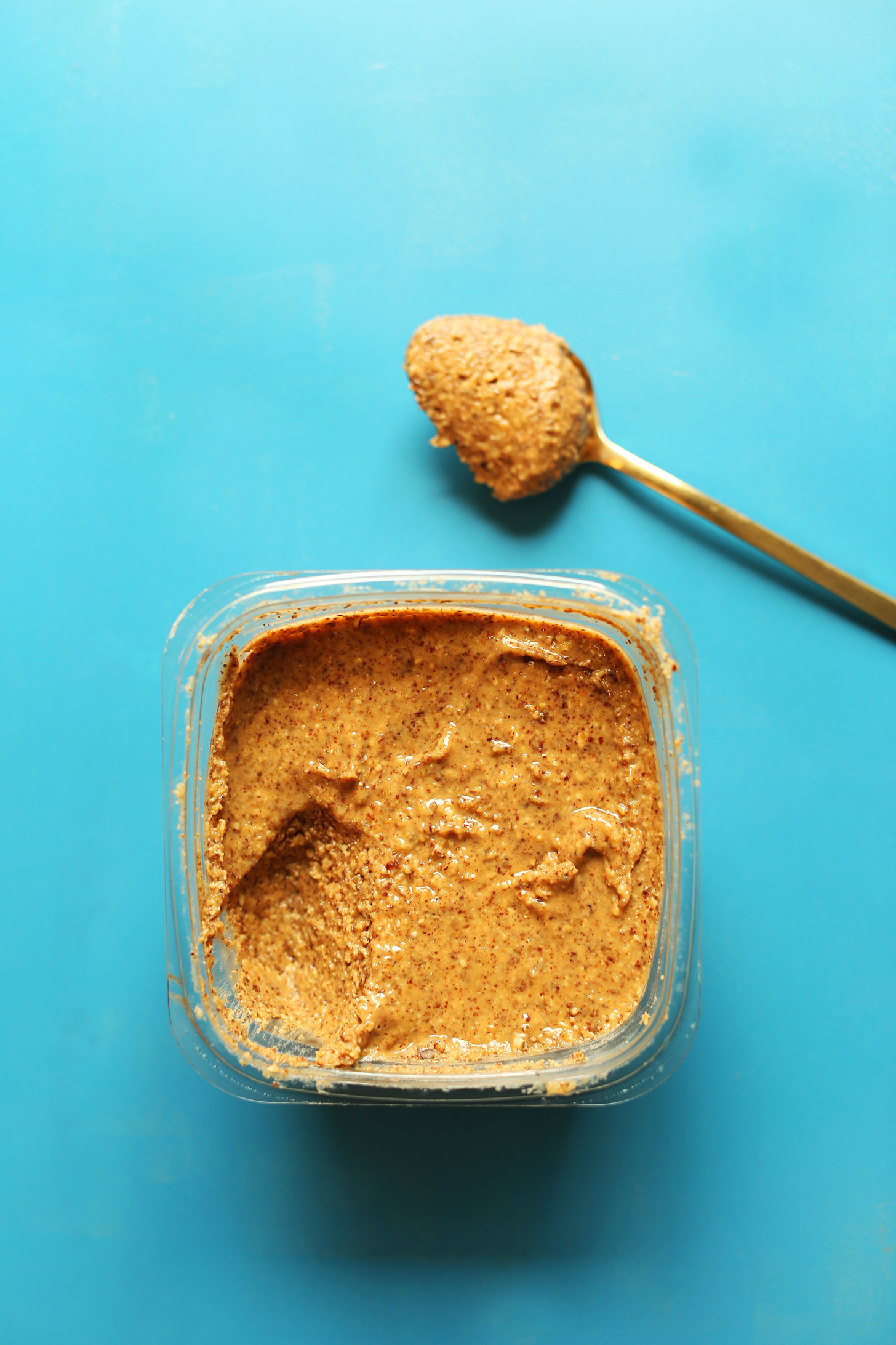 Container of almond butter for making our homemade gluten-free vegan Almond Butter Cup Bars recipe
