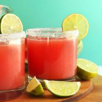 Lime wedges around glasses of Watermelon Margaritas
