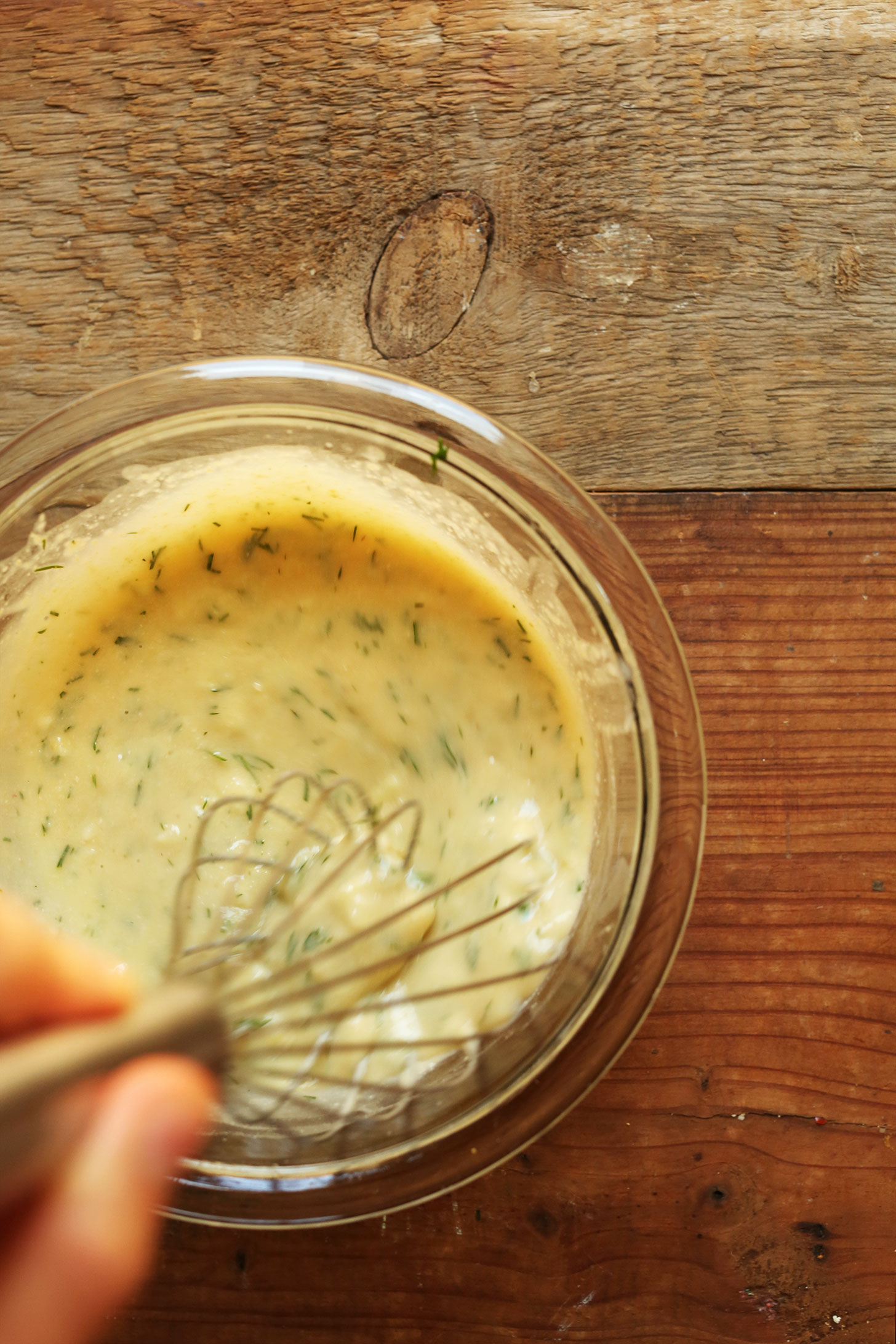 Whisking together Garlic Dill Sauce for our Broccoli Sweet Potato Chickpea Salad recipe