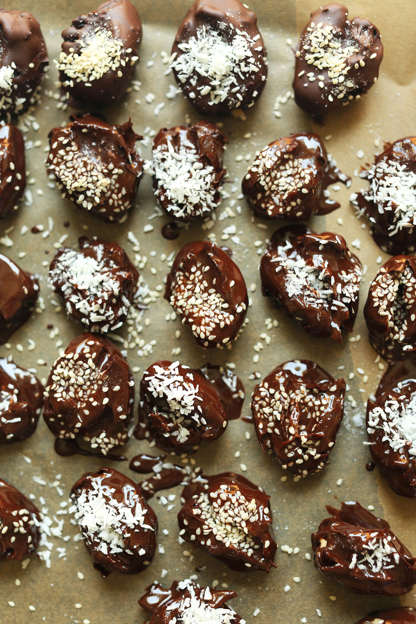Parchment-lined baking sheet with Tahini-Stuffed Dates sprinkled with shredded coconut