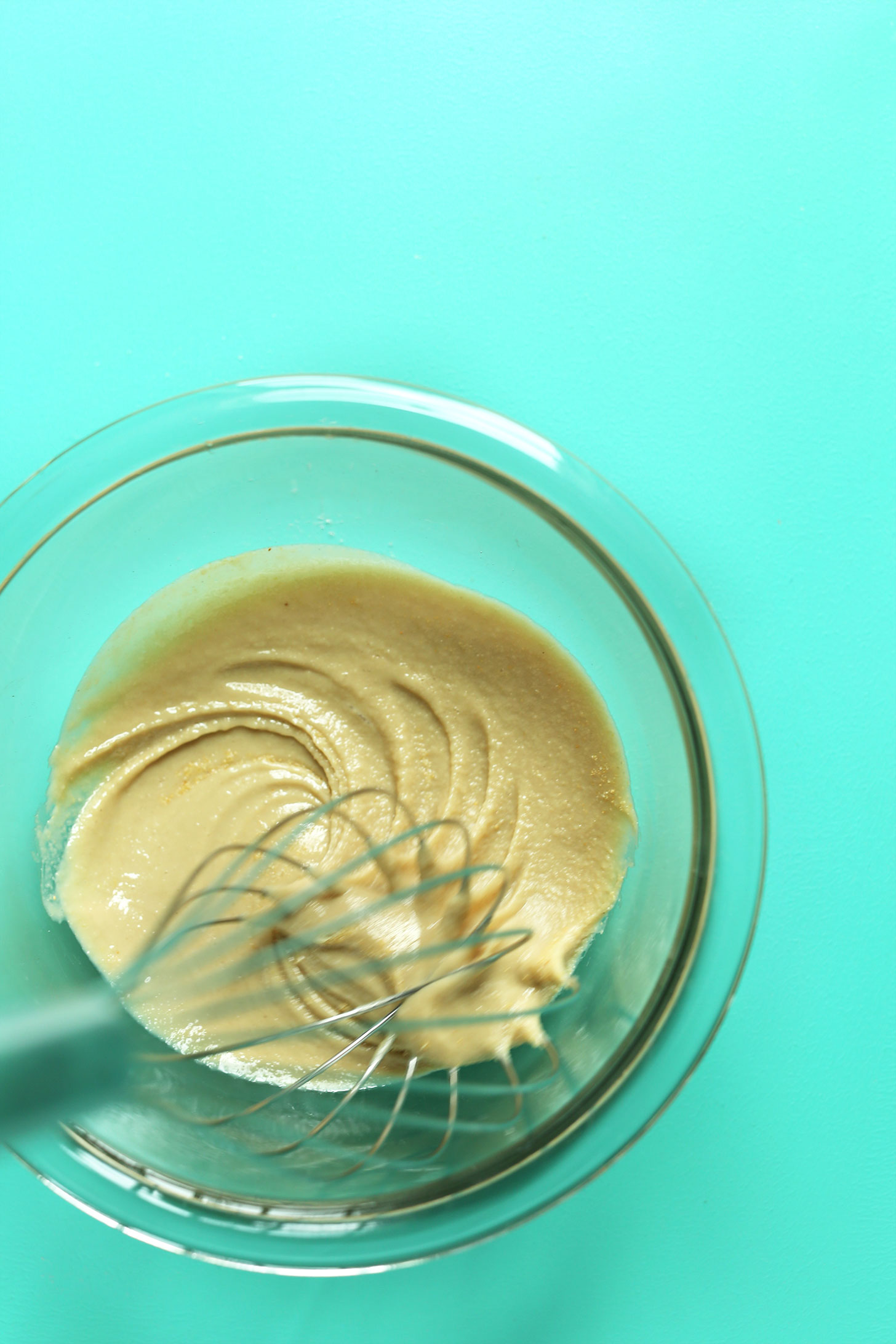Whisking tahini sauce for a smooth texture