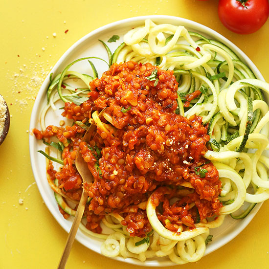 Plate of zucchini noodles topped with Vegan Lentil Bolognese