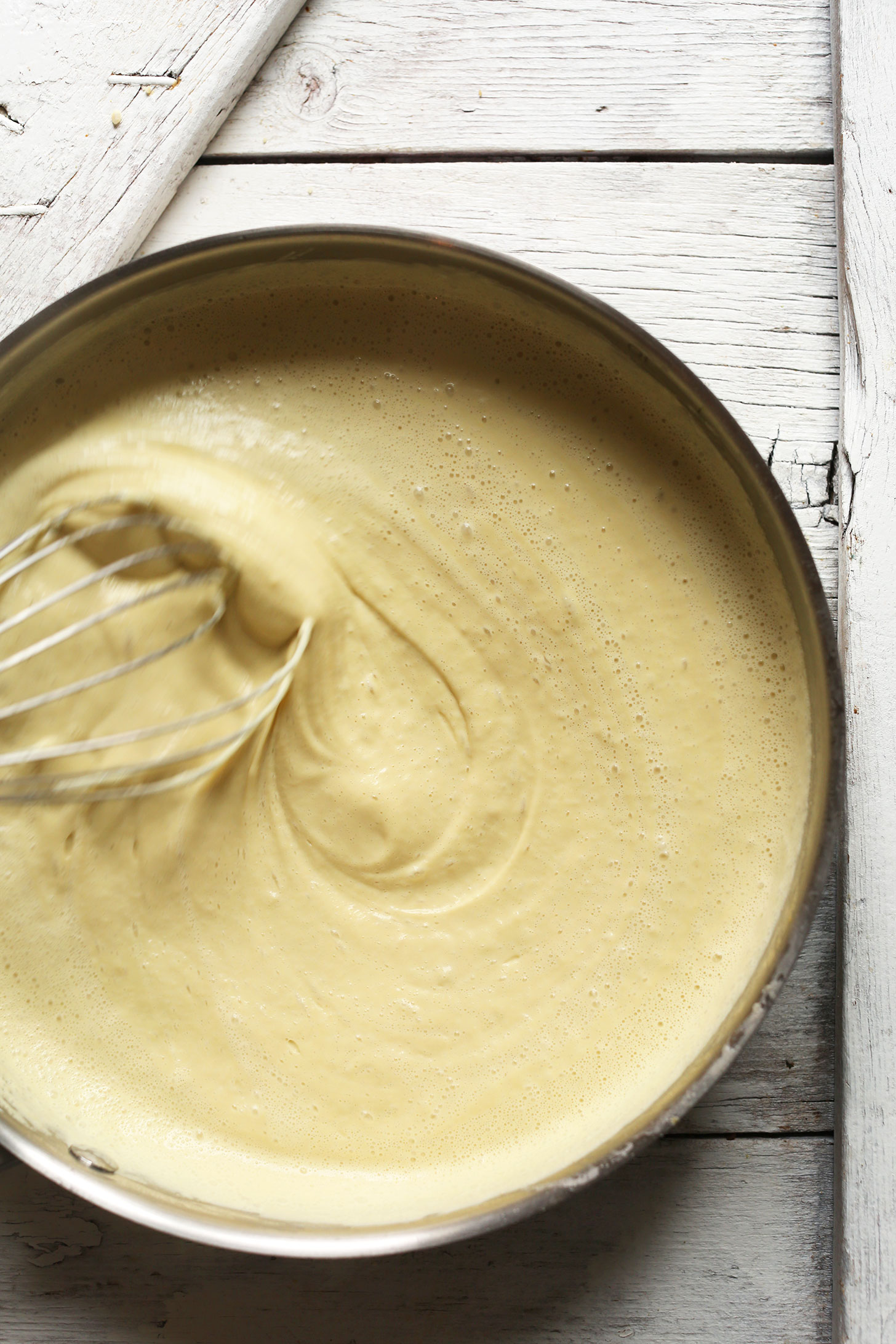 Whisking together cheese sauce for our Amazing Cheesy Cauliflower Rice Broccoli Bake