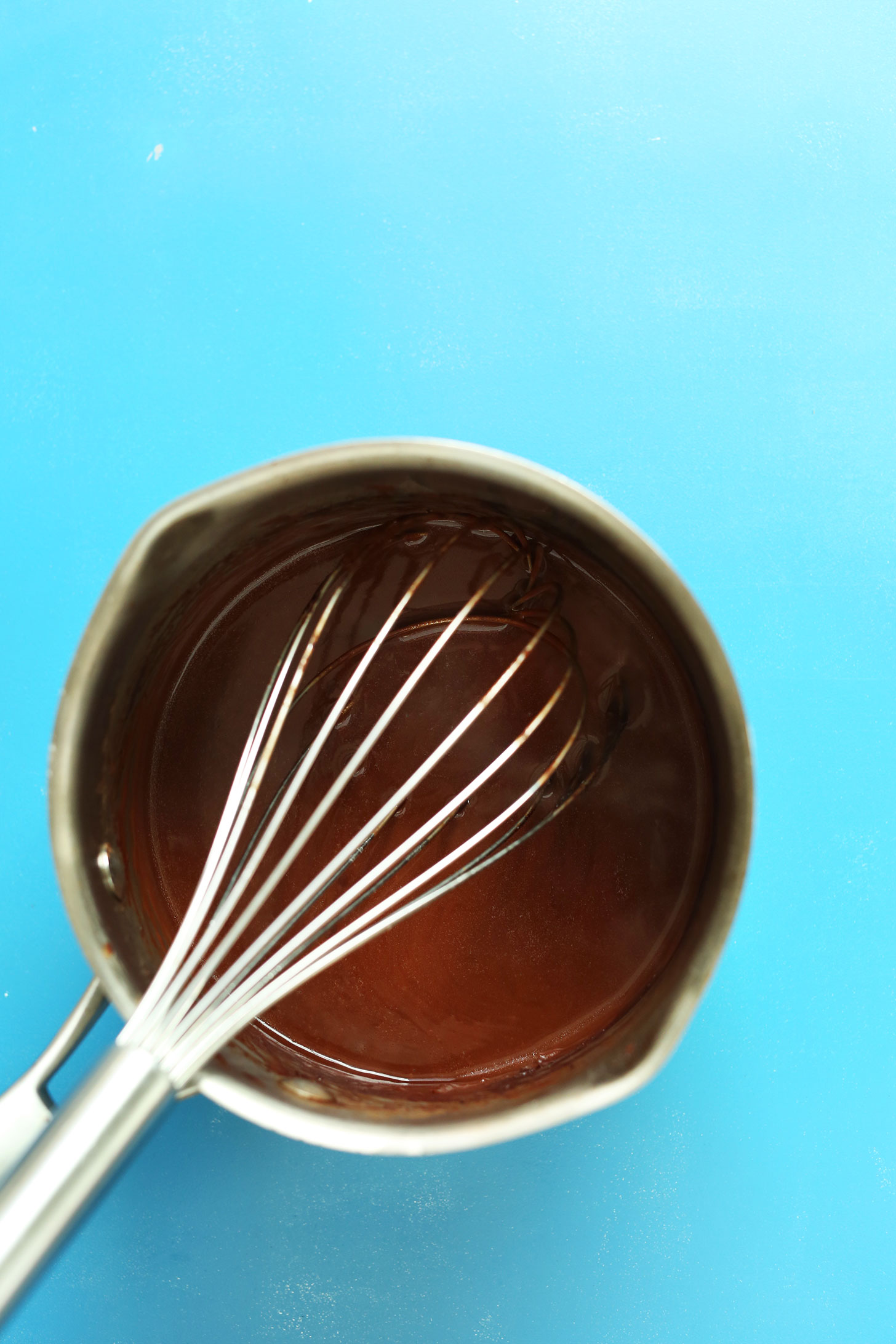 Whisking together ingredients for easy homemade naturally-sweetened chocolate sauce