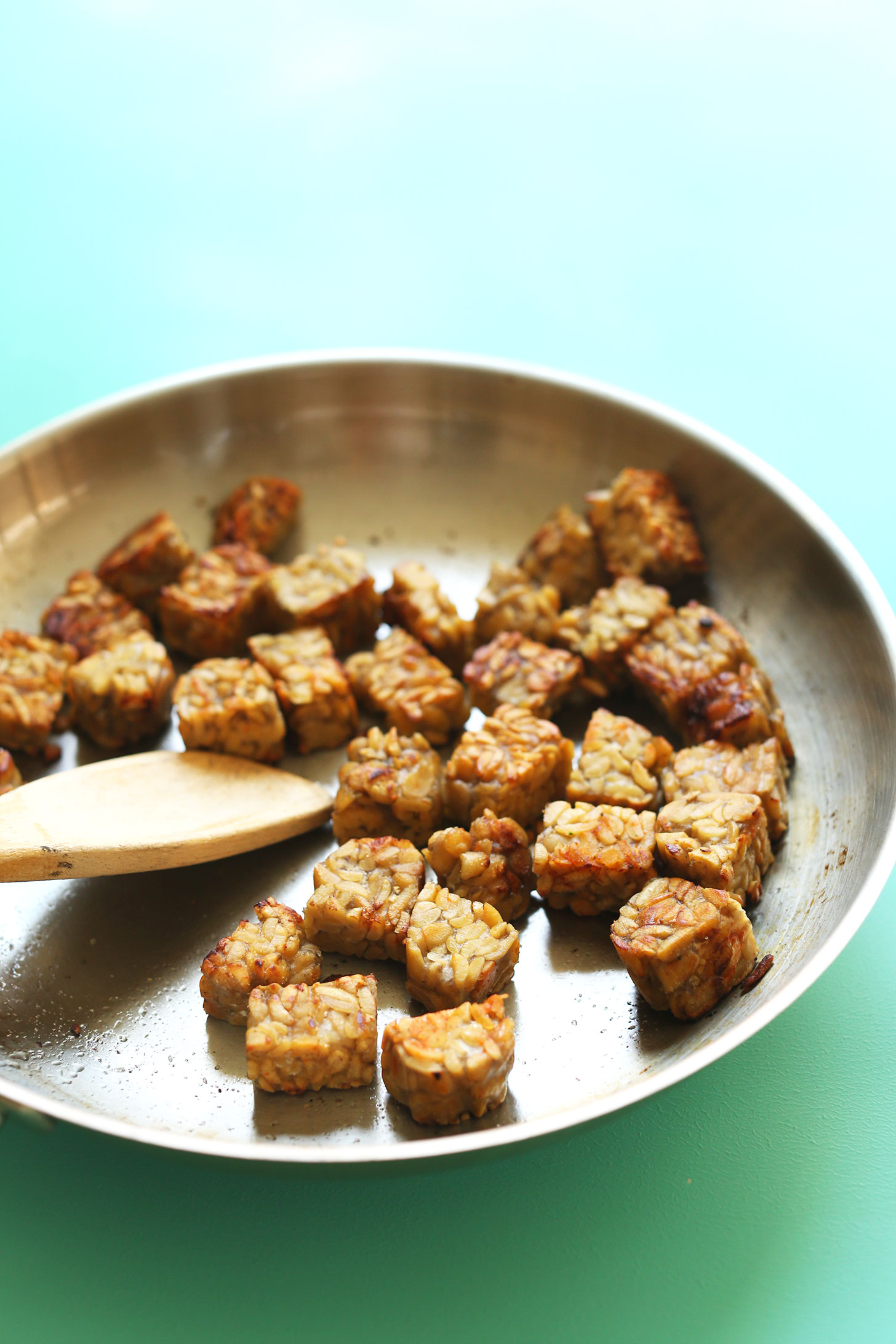 Cooking cubes of tempeh for our Smoky Tempeh Burrito Bowls recipe