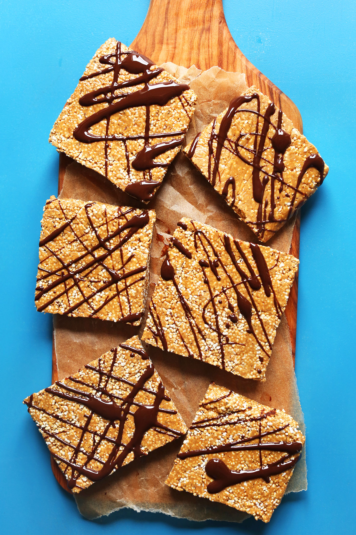 Wood cutting board with 6 squares of our Easy No Bake gluten-free Vegan Protein Bars recipe
