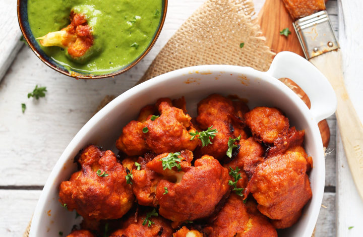 Dipping a vegan Red Curry Cauliflower Wing into Green Chutney dipping sauce