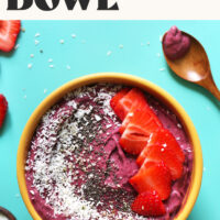 Overhead shot of our berry smoothie bowl recipe topped with fruit, nuts, and seeds