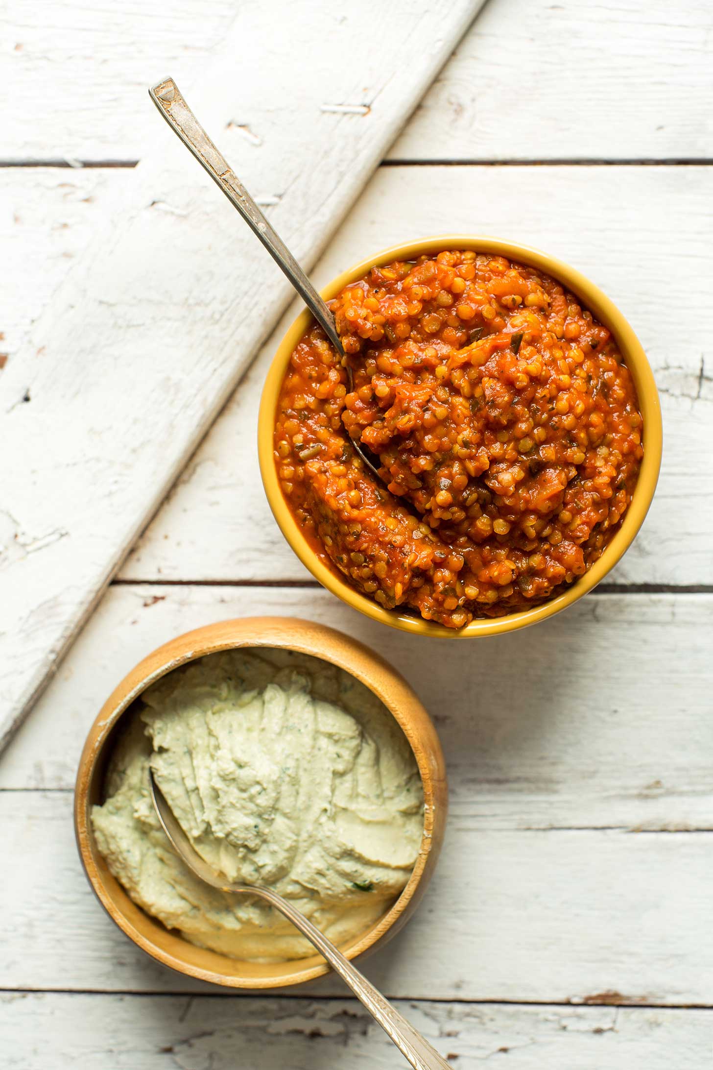 A bowl of lentil red sauce and a bowl of vegan cheese for making homemade protein-packed plant-based lasagna