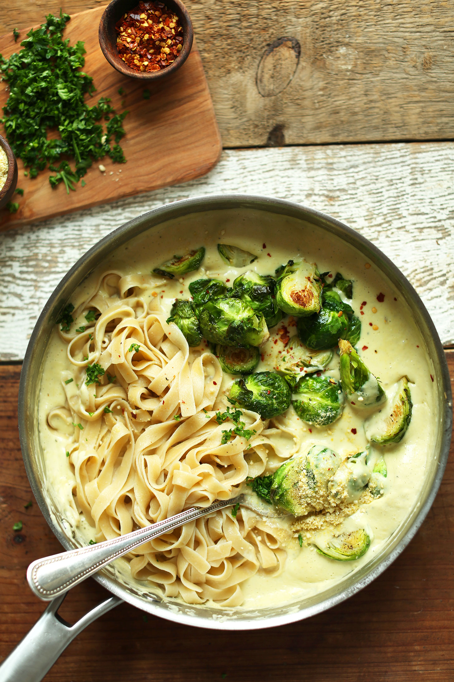 INCREDIBLE 30-minute White Wine + Garlic Alfredo Pasta with Roasted Brussels Sprouts! Quickly becoming a fan favorite for good reason! #vegan #glutenfree #pasta #recipe #plantbased #minimalistbaker