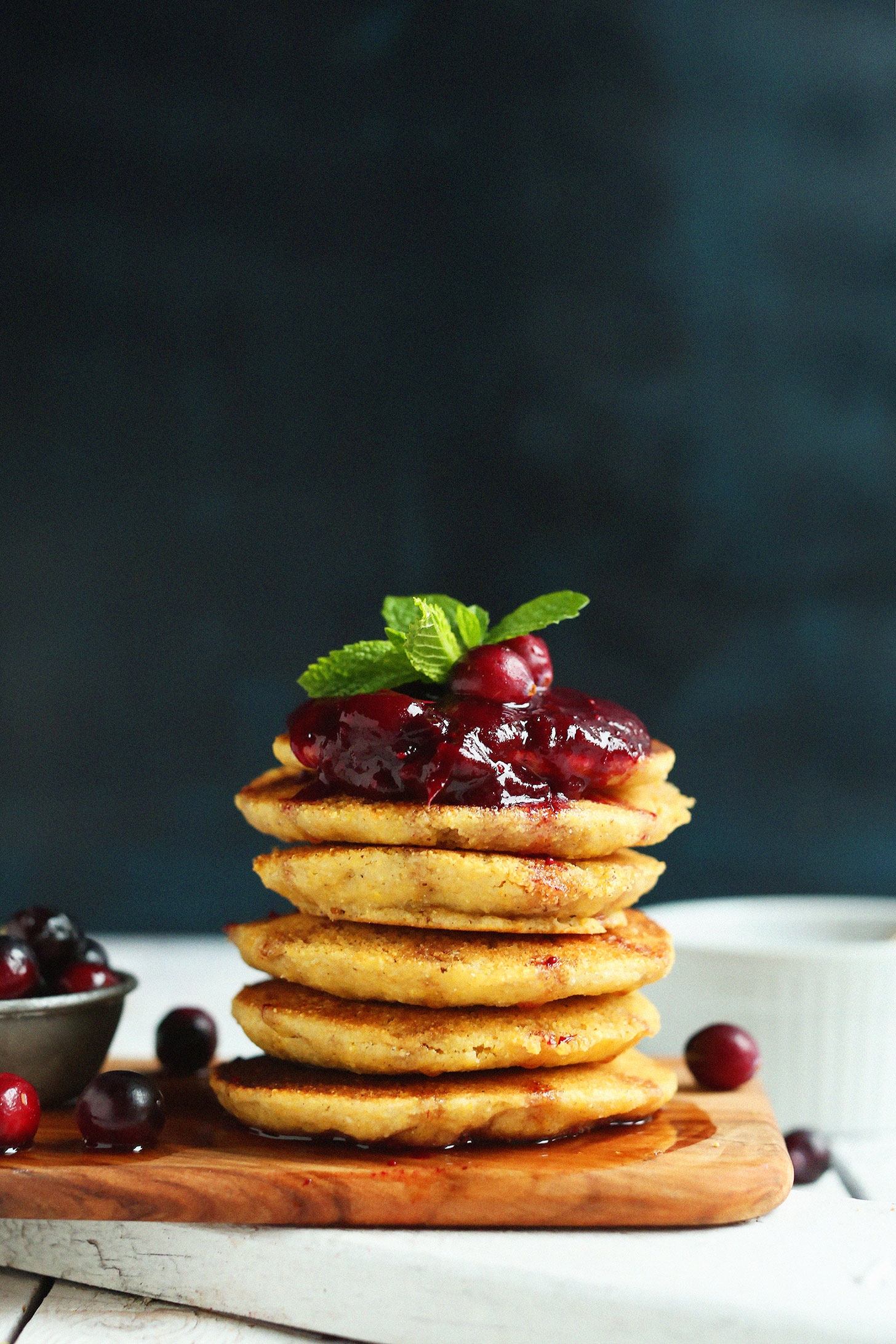 Stack of our gluten-free vegan cornmeal pancakes recipe with cranberry compote