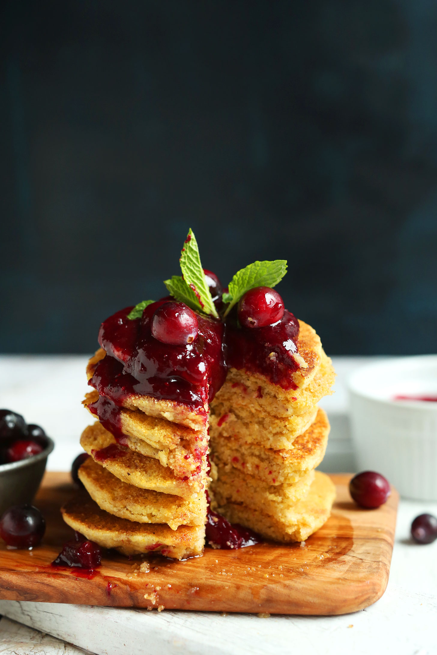 Partially eaten stack of Cornmeal Pancakes with Cranberry Compote for a tasty gluten-free breakfast