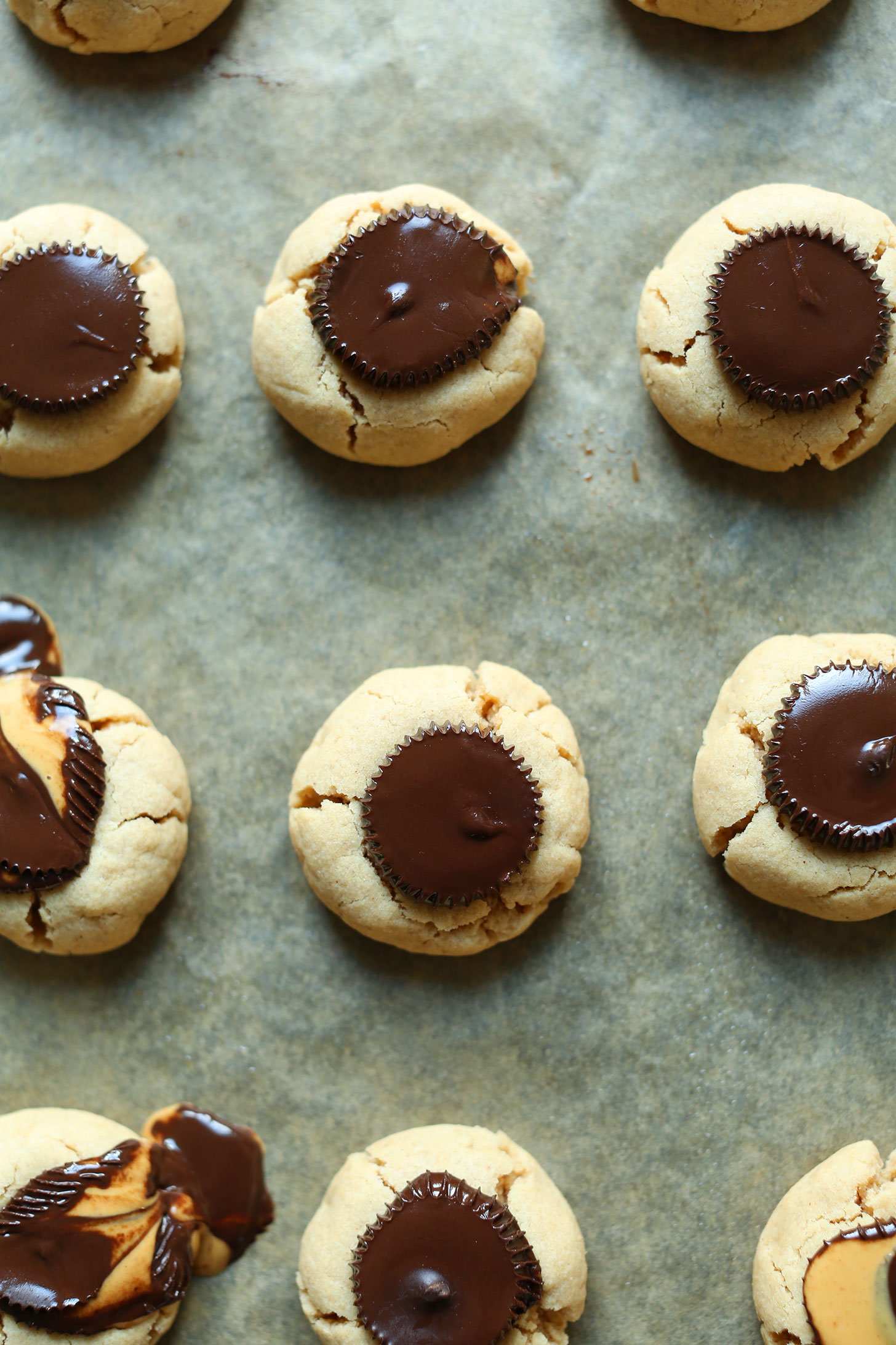 Parchment-lined baking sheet filled with freshly baked gluten-free vegan Peanut Butter Cup Cookies
