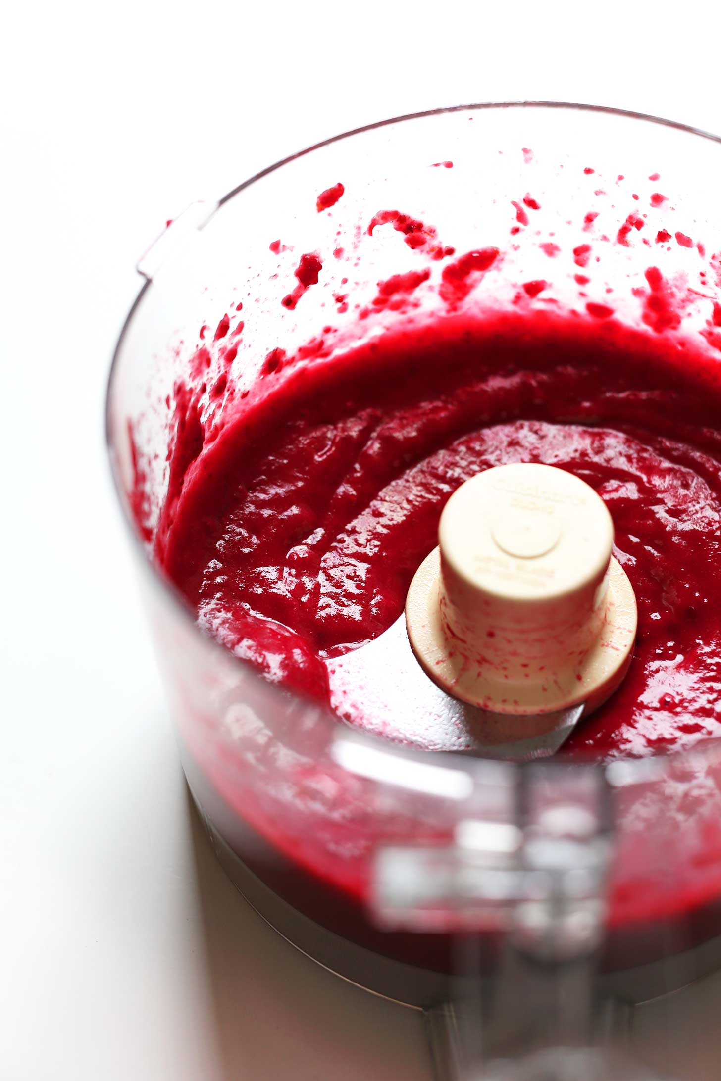 Food processor with freshly blended Cranberry-Pear reduction for a New Year's Eve beverage