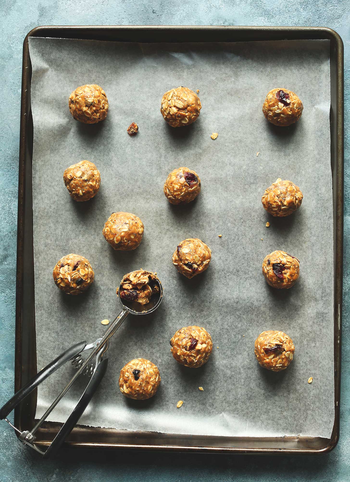 Parchment-lined baking sheet with protein and fiber-rich energy bites