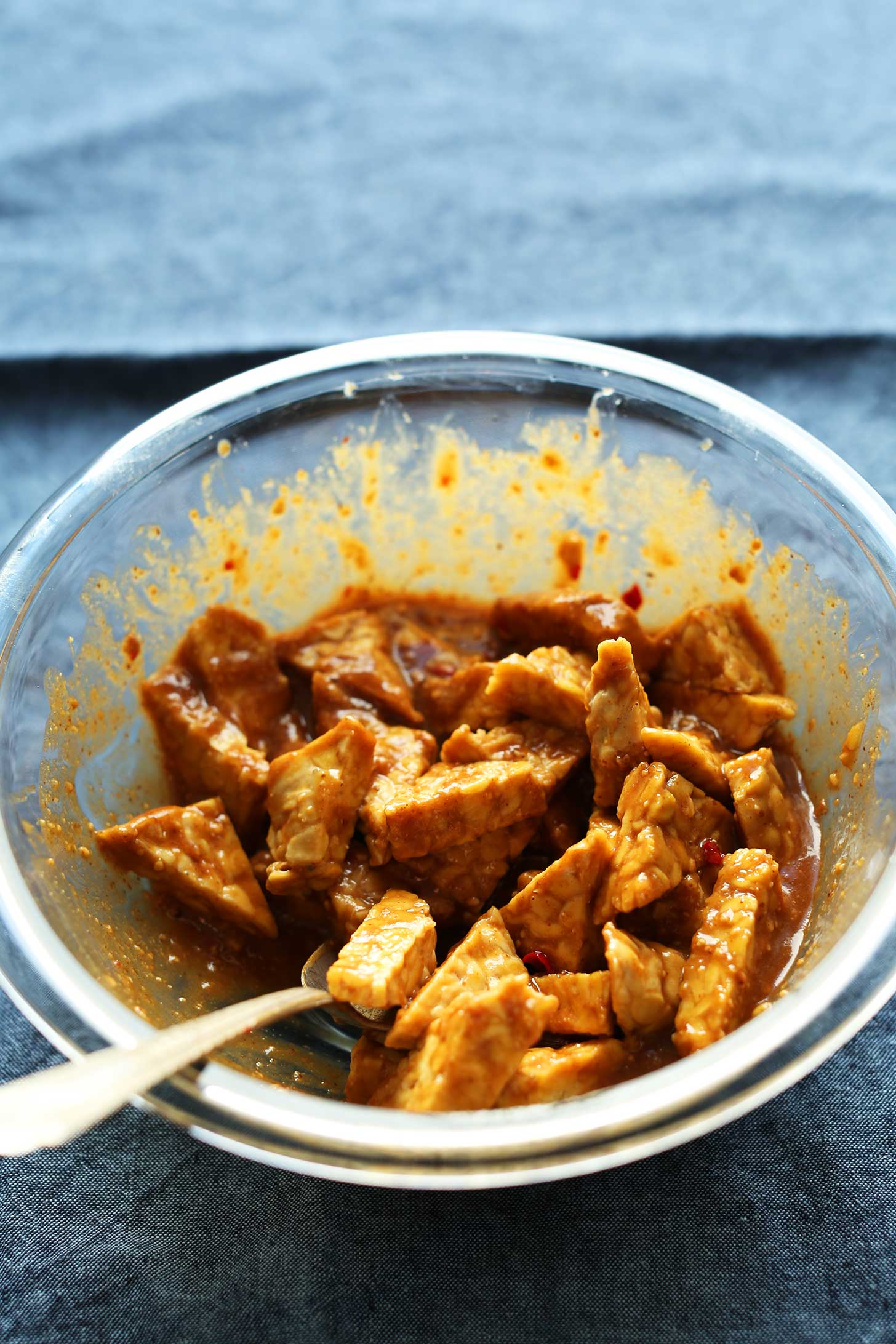 Marinating tempeh in homemade peanut sauce for a protein-packed vegan dish