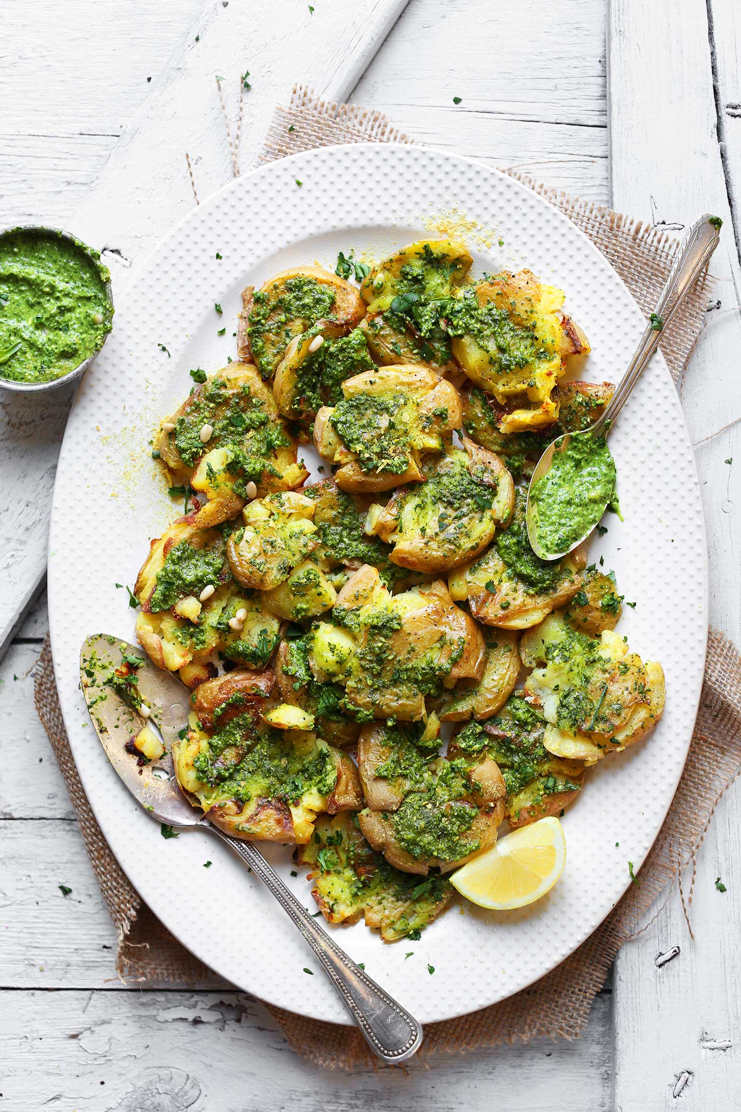 Platter full of Smashed Potatoes with Garlic Herb Pesto for an amazing vegan side dish