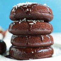 Stack of four homemade Baked Chocolate Donuts dripping with glaze