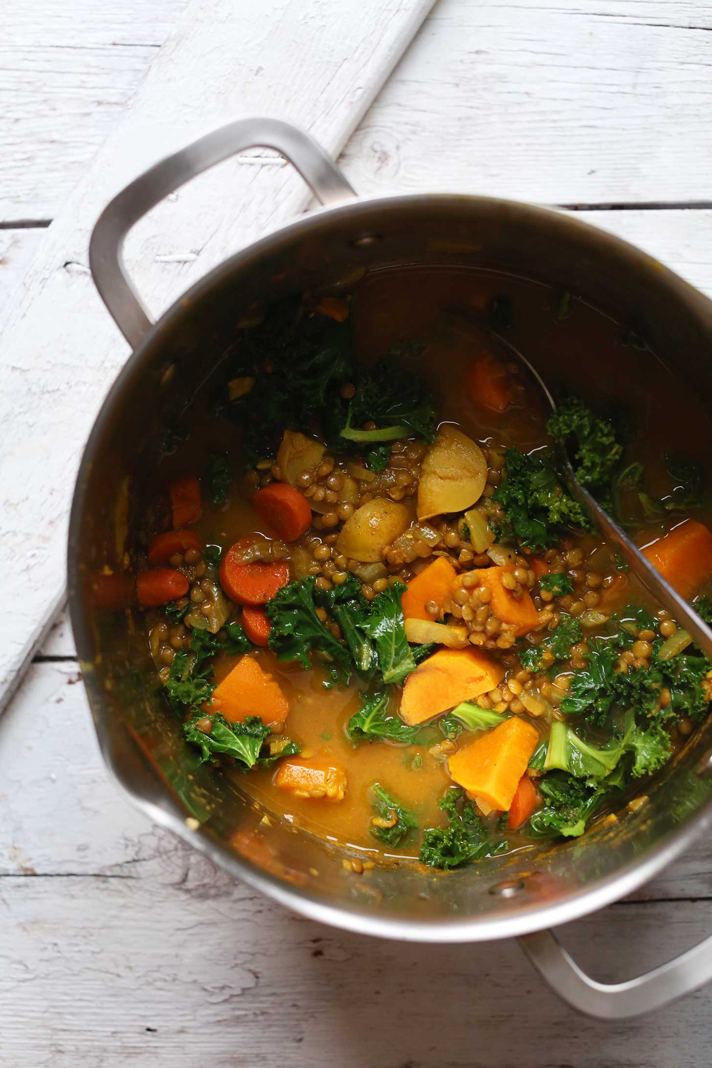 Stirring a big pot of our healthy vegan curry soup recipe