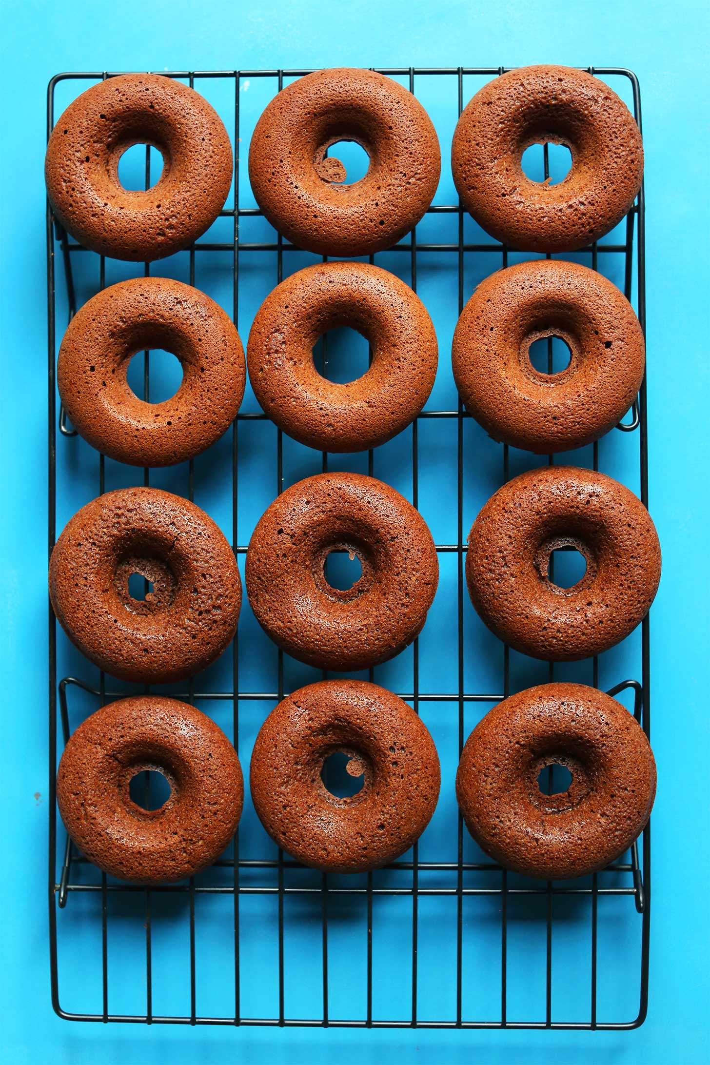 Cooling rack with freshly baked gluten free vegan Chocolate Donuts