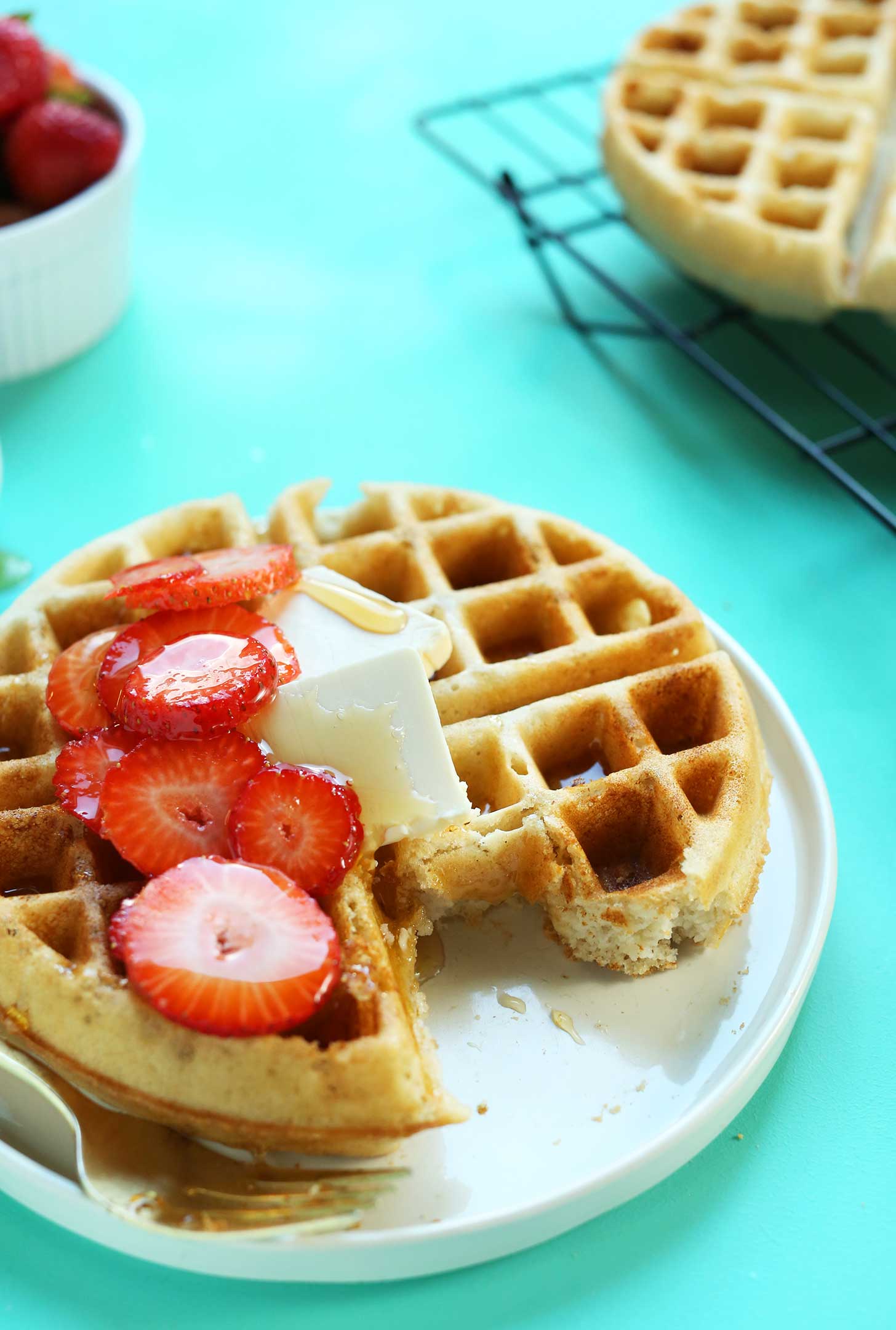 Partially eaten waffle on a plate for a gluten-free vegan breakfast