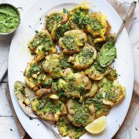 Platter filled with Vegan Smashed Potatoes topped with pesto